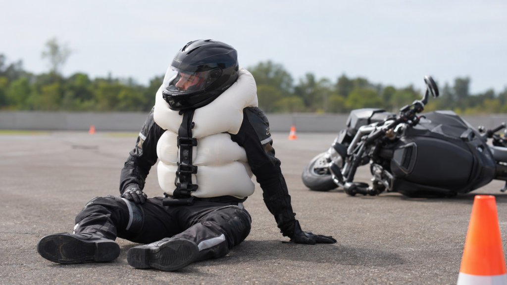 Motorcycle airbag vest fully inflated around a rider’s chest, back, and neck during a controlled safety demonstration
